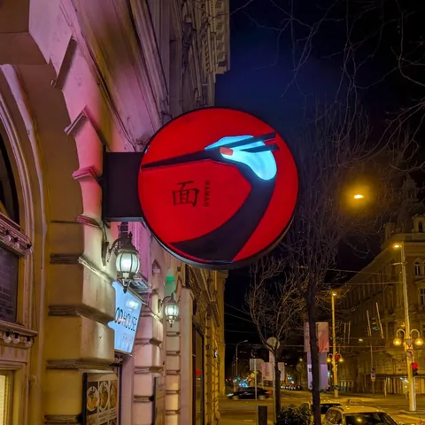 This Japanese restaurant logo is simultaneously a Japanese crane and a hand holding chopsticks.