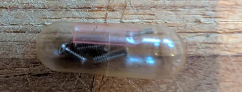 A gel cap filled with teeny tiny screw