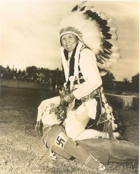 A Native American tribesman scalps an effigy of Adolf Hitler, 1940's