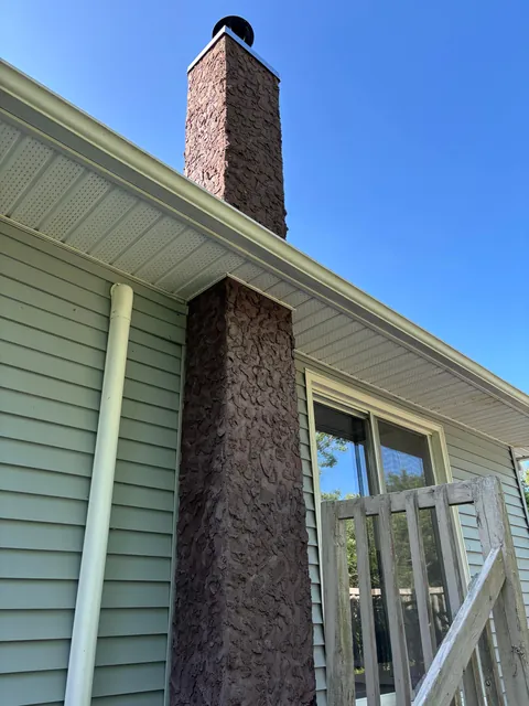 What is this on my brick chimney? Can I get it off myself?