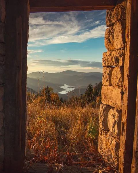 Tara National Park through the door of an abandoned hut, Serbia
