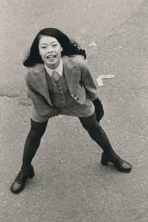 In 1974, Masahisa Fukase photographed his wife, Yōko Wanibe, every morning from the window of their apartment in Tokyo as she left for work.