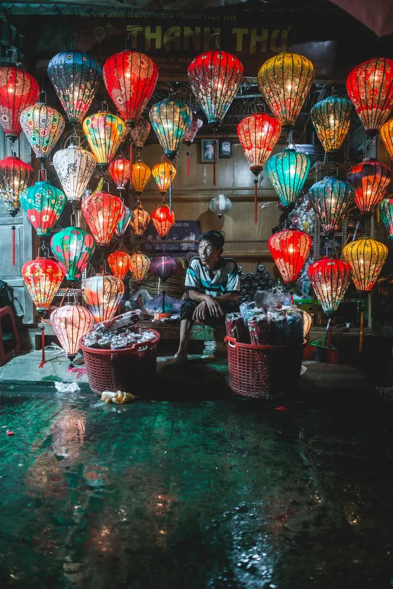 ITAP of a lantern maker in Hội An, Vietnam in the rain at night.