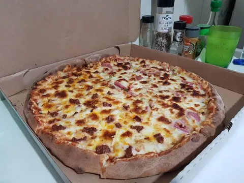 A local bakery in my country sells the family size stuffed crust pizza for $4 and it is really good, it is meat lovers btw with extra cheese, the cups and shakers for scale.