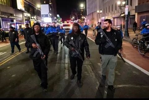 Armed members of the Black Panther Party walk through downtown and join protest [OC]