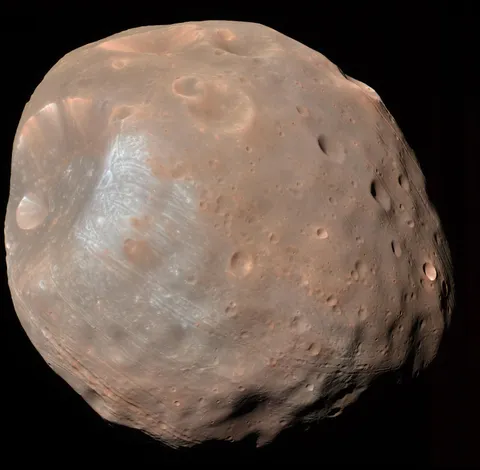 Newly analyzed photos of Mars' moon Phobos suggest it may be a captured comet. Previously unpublished img from the Mars Express spacecraft revealed Phobos's surface characteristics, such as its brightness &amp; porous nature, resembling those of comets.