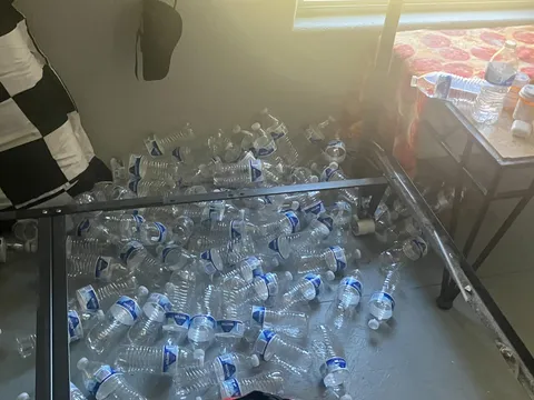 My boyfriend throws his empty water bottles behind the bed.