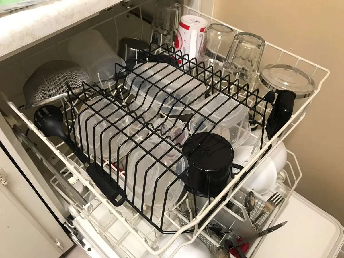 I use an upside down metal dish rack to keep my Tupperware from flipping upside down in the dishwasher.
