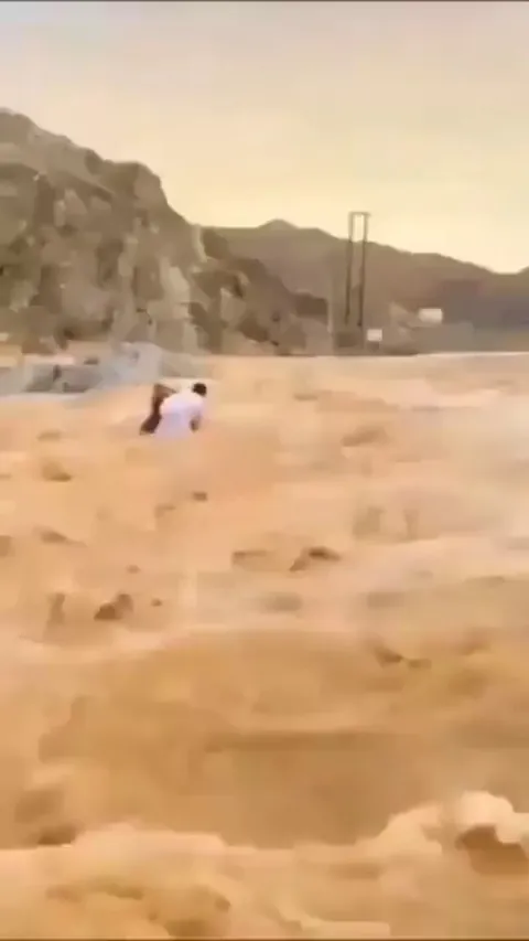 Here is a Man Saving two kids from certain death.