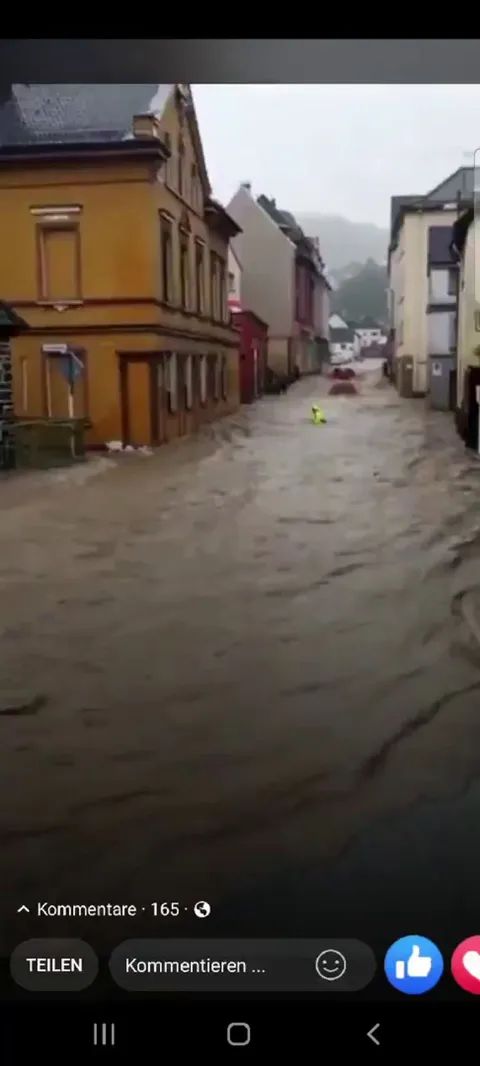 People saving a frieman from drowning during today's flooding catastrophe in Germany