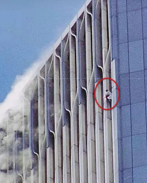 This photo shows a person on the North Tower, somewhere on the 107th Floor, where the Windows on the World Restaurant used to be. NYC, September 11, 2001