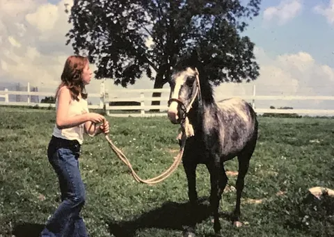 My teenage mom in the 70s with her first horse, one she paid for by working underage at a movie theater.  