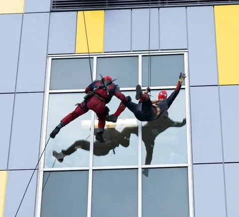 Tactical team personnel dressed up as Spiderman and Deadpool rappel down the walls of the Montreal Children's Hospital