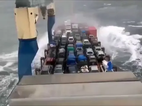 Cars being transported on an open deck catch fire after salty water shorts their batteries.