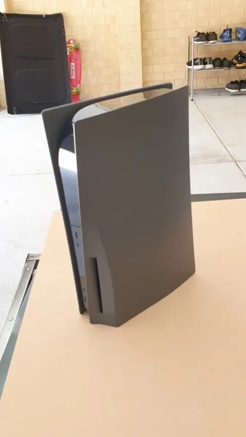 Decided to spray the PS5 a dark grey, super stoked with the results! (Now to get up the courage to match the controllers)