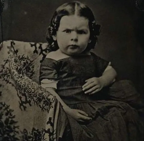 Portrait of a young grumpy girl from the 1850s
