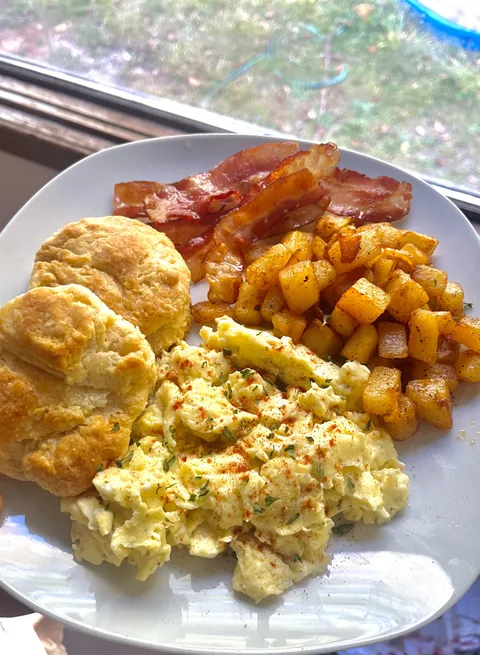 Bacon, eggs, home fries, and homemade biscuits 