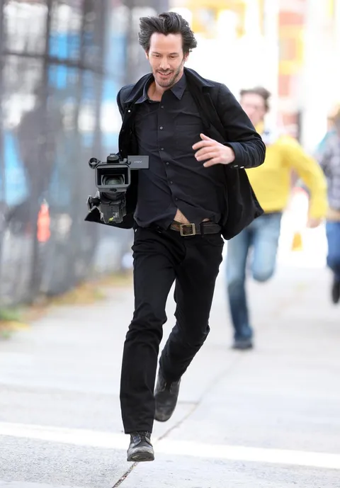 PsBattle: Keanu Reeves running after stealing the camera of a paparazzi