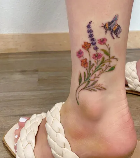 Fuzzy bee and wildflowers done by Harmony at Hidden Tattoo in Lancaster, CA