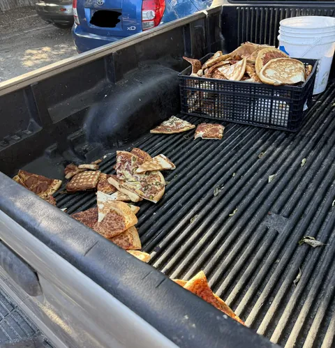 A truck bed full of loose pizza slices I saw today