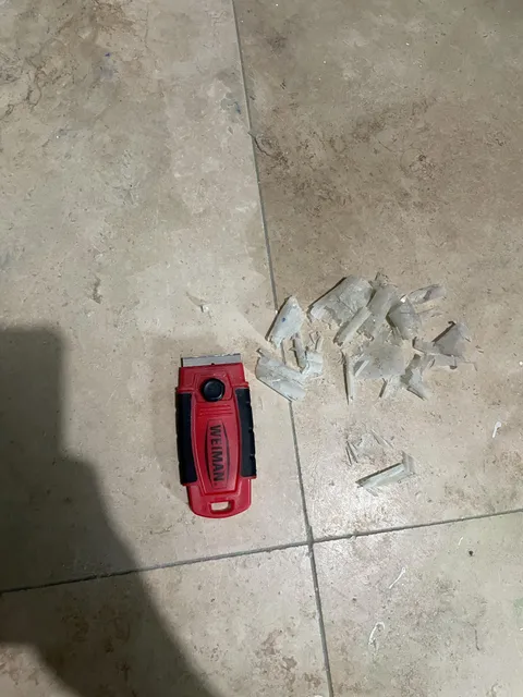 Scraping my tile with razor and this is coming off - what is it?