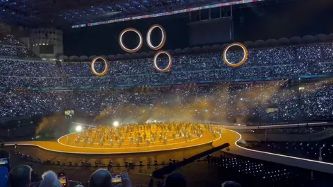 dramatic arrival of the Olympic rings at the 2026 Winter Olympics Opening Ceremony