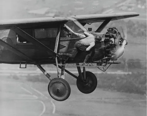 One of the Hunter brothers checks the engine of their plane while in flight. This was during their record 23 day non stop flight: 11 of June 1930 to 4 of July 1930. Source in comment