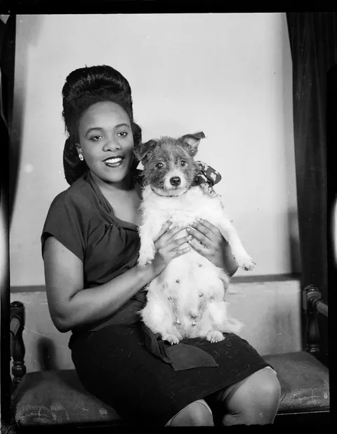 Young lady posing with her dear dog for a tummy shot, Safety Kodak, circa 1946.