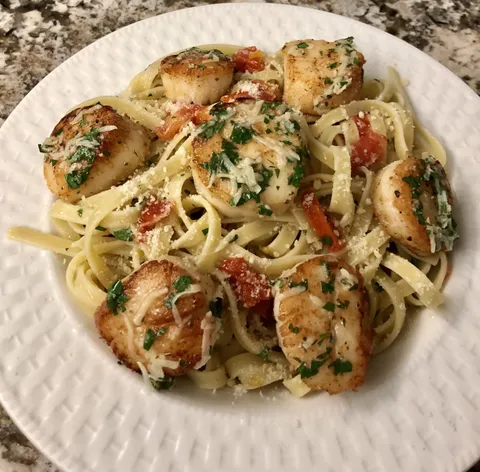 Linguine with scallops in a garlic herb sauce by me
