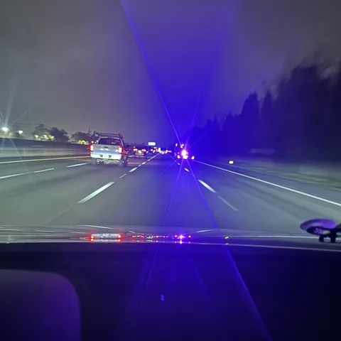 This car hauler has a purple floodlight blinding every car behind them