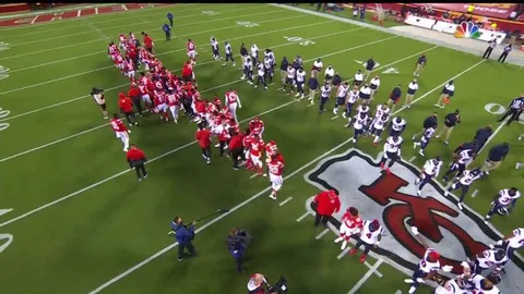 The Chiefs and Texans, arm-in-arm in a show of unity, receive boos from the Kansas City crowd