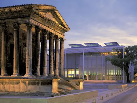 Two intact buildings, built two thousand years apart, standing next to each other. The Roman Maison Carrée and Norman Foster's Carré d'Art, Nimes, France