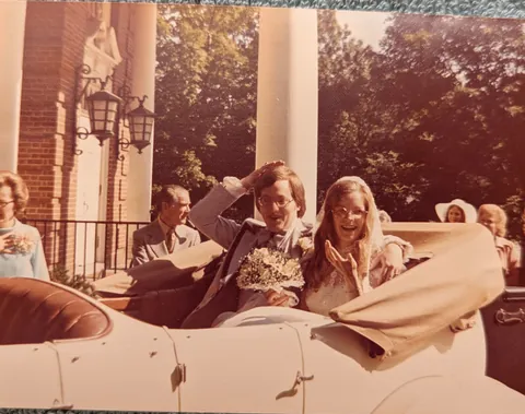 My parents leave their wedding in style in a vintage Rolls Royce.  1975.