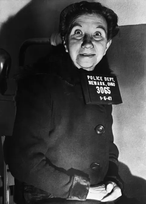 Laura Belle Devlin after her arrest in 1947 for murdering and dismembering her 75-year-old husband with a hacksaw, throwing some of his body parts in the wood stove and the rest in their backyard in Newark, Ohio.