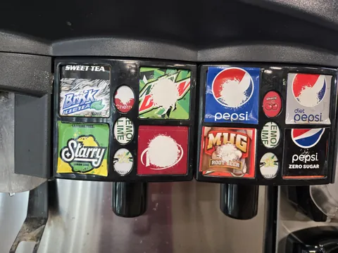 The wear pattern on this soda machine showing which drinks are most popular