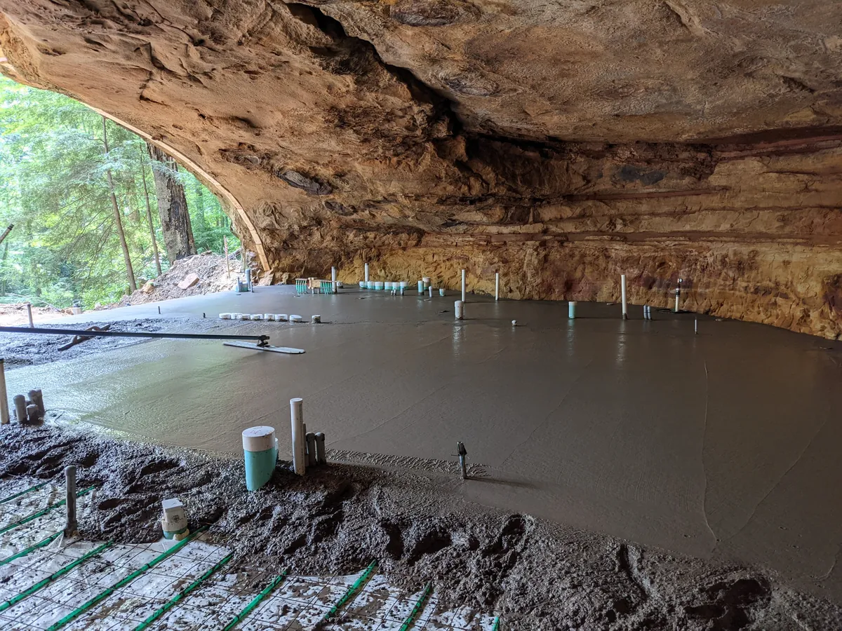 Is building under a huge rock like this safe? My first thought when I say this was earthquakes.