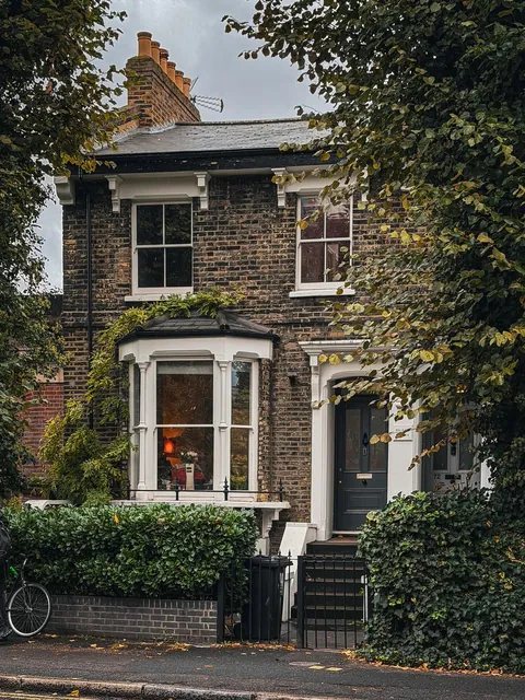 Terraced house with a bay window in Hackney, East London, England.