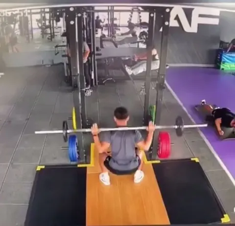 Man gets a muscle cramp while working out during an earthquake.