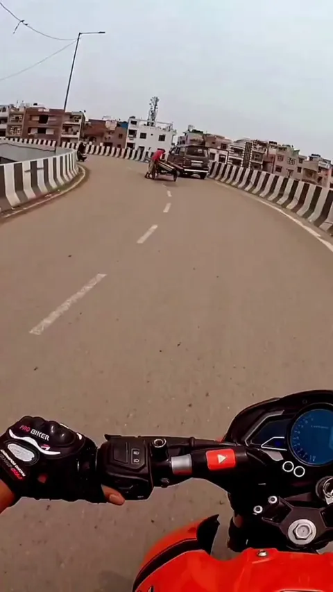 biker helping out a man carrying load on a bridge