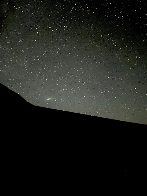 I captured Andromeda galaxy by my phone camera,Outside my tent.