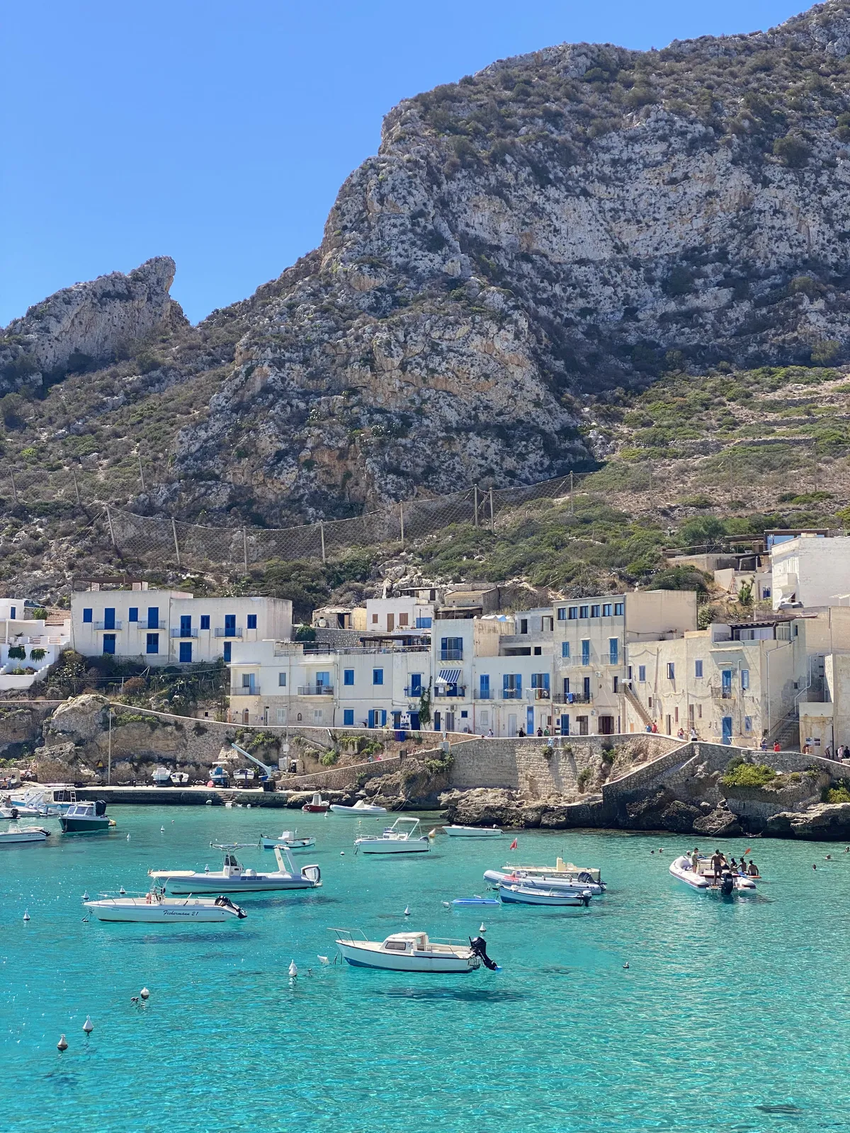 The water is so clear, that it looks like the boats are levitating.