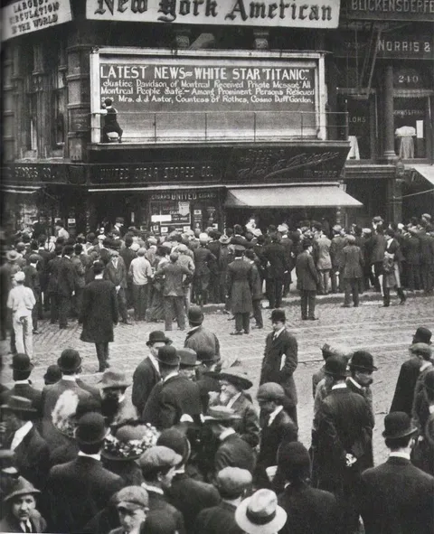 A young man writes the Titanic disaster announcement in Times Square, New York, 1912.