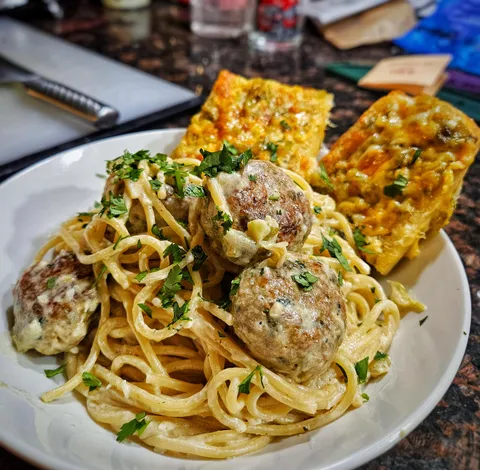 It's chile season! Green chile spaghetti with green chile chicken meatballs and green chile garlic bread.