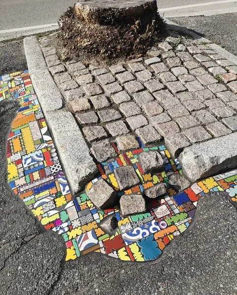 French Artist “EmEmEm”paves cracks and holes with mosaics. This is also known as “Flacking”.