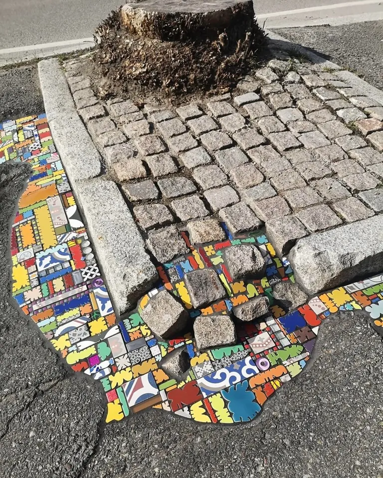 French Artist “EmEmEm”paves cracks and holes with mosaics. This is also known as “Flacking”.