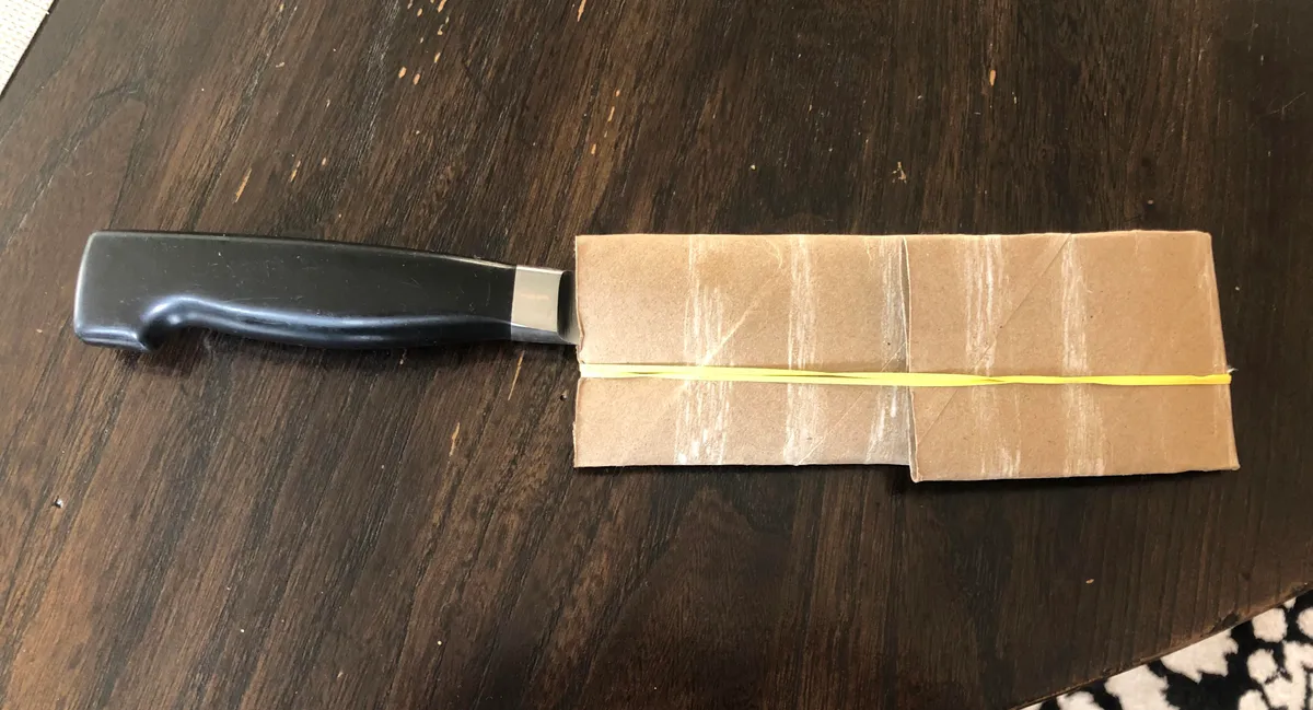 Transport your knives with an empty paper towel roll and rubber band