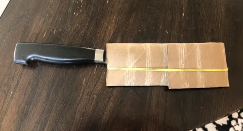 Transport your knives with an empty paper towel roll and rubber band
