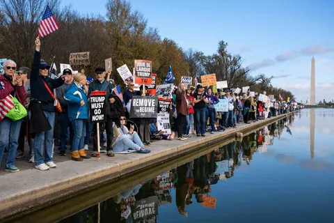 People rally at the Lincoln Memorial calling for Trump’s impeachment.