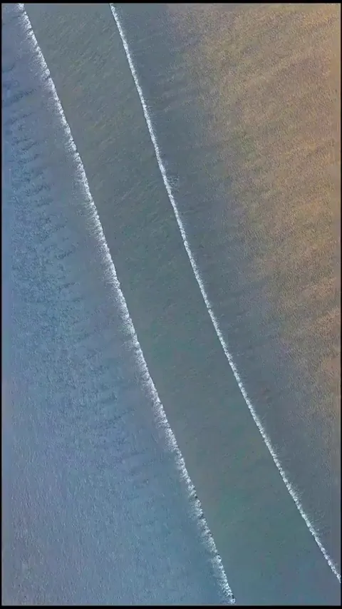 Aerial view of two waves intersecting each other 