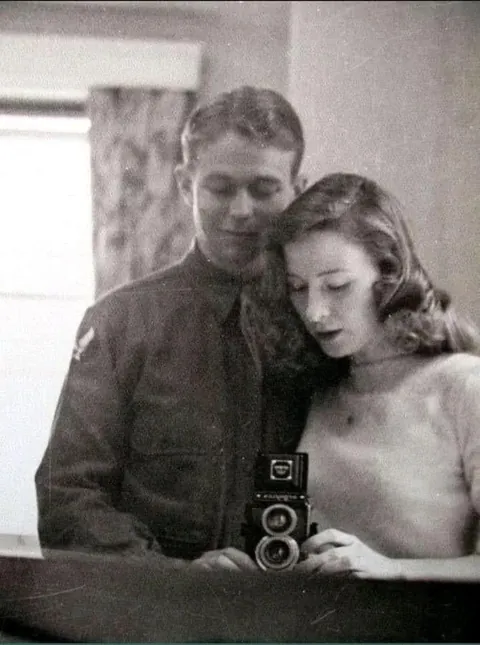 U.S. Army Air Forces 2nd Lieutenant Quentin C. Aanenson takes a mirror selfie with his girlfriend Jacqueline Greer before leaving for Europe, c. March 1944